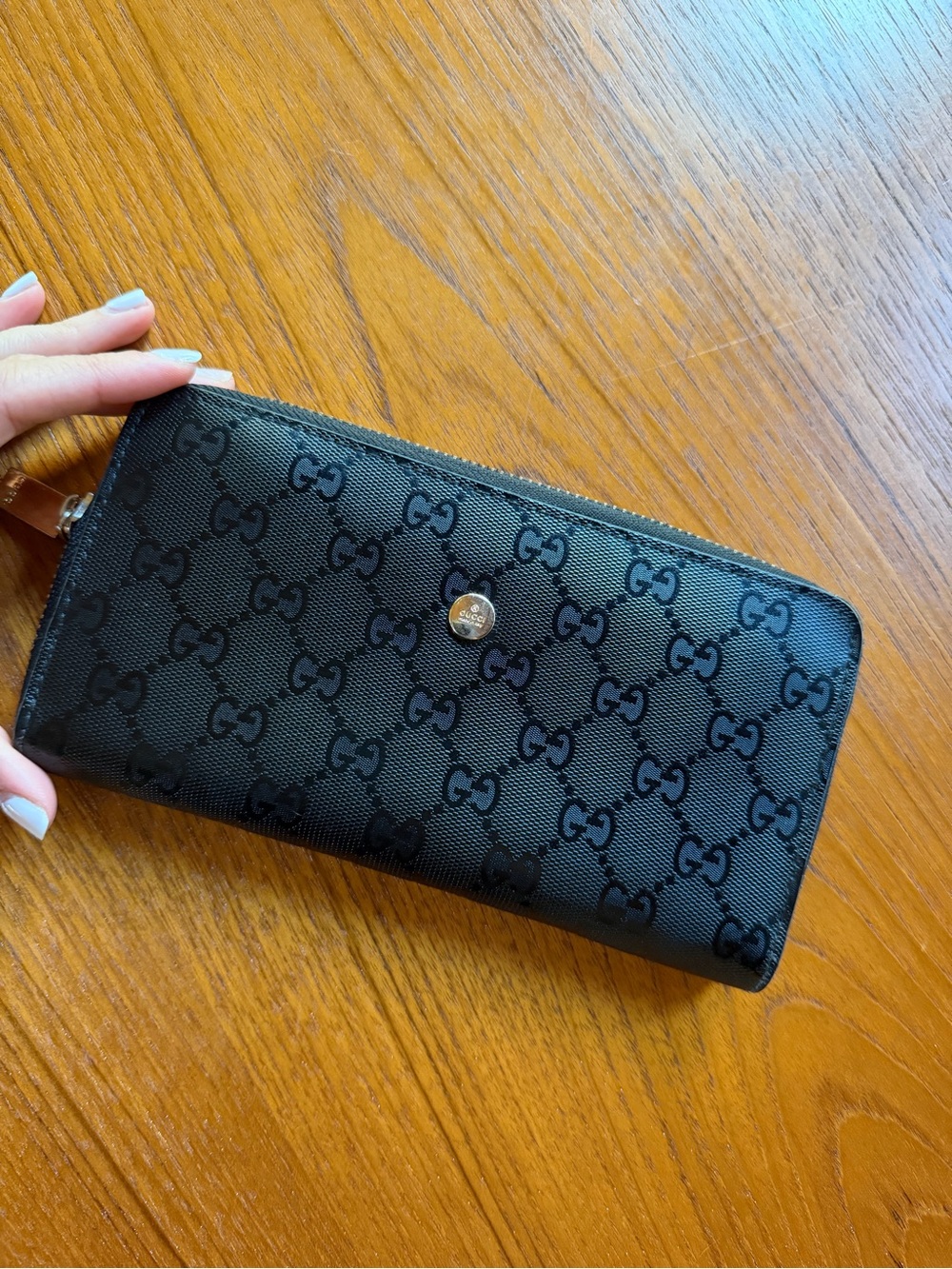 Gucci black GG embossed zip wallet with gold button